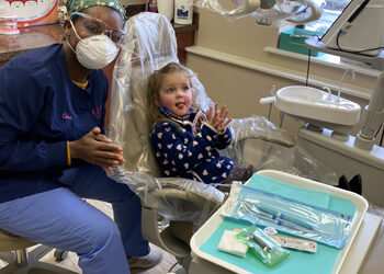 Our staff with a child at Dr. Dani Dental clinic